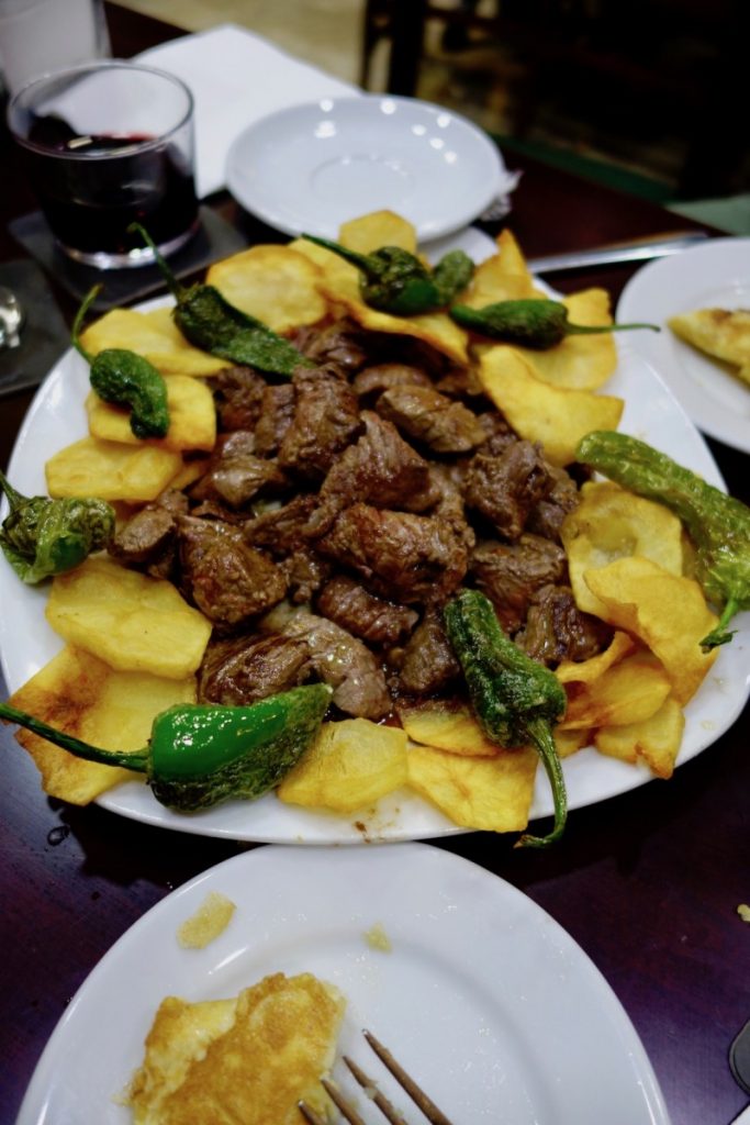 Steak, padron peppers, and potato chips at Aquarium Restaurant in Valencia, Spain - Best restaurants in Valencia Spain | https://passportandplates.com